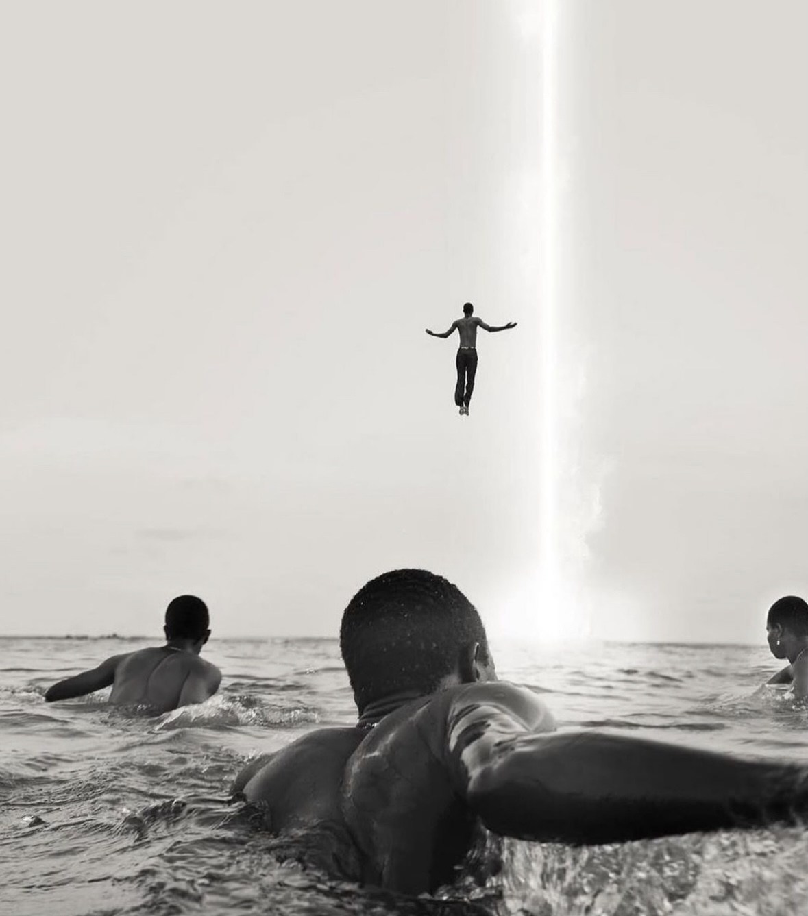 Surreal ascension - man floating into beam of light